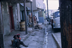 Children Sitting on the Sidewalk of a Busy Street in Saint John, Antigua