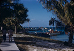 Walter W. S. Cook and another man walk towards the North Cat Cay marina