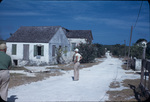Two men look at houses in a Rock Sound neighborhood on Eleuthera, Bahamas
