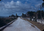Two men exit a Rock Sound cemetery, Eleuthera, Bahamas