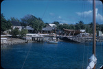 View from the sea of a boat under construction near a coastal village on Man of War Cay, Abaco, Bahamas