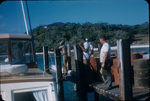 Five men and some steel drums are on a dock near a boat on Walker’s Cay, Abaco, Bahamas