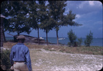 A man near an old wooden boat near Nicholls Town, Andros, Bahamas