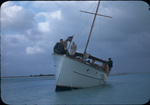 Four men sit on a boat stuck near South Bight, Andros, Bahamas