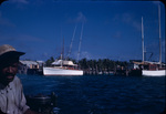 A man in a motor boat moves away from a Bimini dock, Bahamas