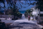 A man walks up a neighborhood street in Dunmore Town, Harbour Island, Bahamas