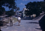 Two men walk down Bay Street in Dunmore Town, Harbour Island, Bahamas
