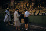 Eleanor Friend Sleight and her daughter Susan buying a souvenir belt from a Bahamian straw vendor