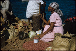 A woman selling beans and ginger in Nassau Harbor, New Providence, Bahamas
