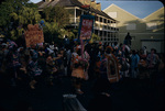 Jonkonnu festival paraders holding signs marching down Bay Street, New Providence, Bahamas