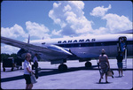 Passengers boarding and exiting a Bahamas Airways airplane