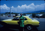Eleanor Friend Sleight in front of a Ford Cortina rental car in Kingston, Jamaica