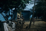 Children beside a zinc roofed house in Jamaica