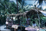 A pregnant woman buying fruits from street fruit vendors in Jamaica
