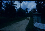 A Ford Cortina automobile driving on a dirt road in Seville, Jamaica