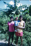 Two women and an infant in front of trees near Moore Town, Portland, Jamaica