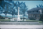 A stone cross monument near a bay in Saint Ann, Jamaica