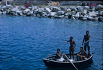 Four boys in a row boat in the harbor of Kingstown, Saint George, Saint Vincent