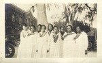 Female students pose in front of White Hall