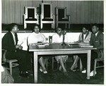 Students converse around a table