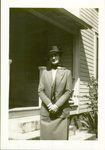 Photograph of Alice Ellen Guild in front of house in dress attire.