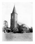 Exterior of first brick church, c. 1940, with Pastor Stephen M. Tuhy