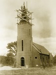 Brick church construction. 1938-39. Workmen on top of bell tower.