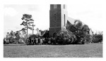 Brick church, c. 1940, with congregation in receiving line