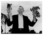 Andrew Duda, Sr. holding two celery bouquets, c. 1950