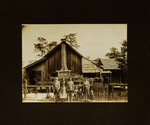 Adults and Children Standing in Front of House