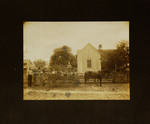 Kids Sitting in Horse-Drawn Wagon and Parents Standing in Front of House