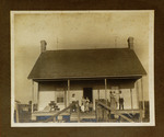 Large Family Standing in Front of House