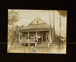 Man Standing on Steps of House