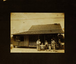 Man, Woman, and Four Children Standing in Front of House