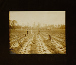 Men and Woman Standing with Children in Crop Field