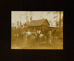 Men, Women, and Children Posing with Horse in Front of House