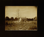 Men, Women, and Children Standing in Field in Front of House