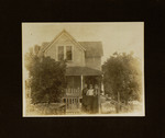 Three Women Standing by Fence in Front of House
