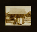 Three Women Standing in Front of House