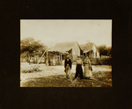 Two Women and One Man Standing in Front of Property