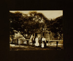 Two Women, Two Men, and Child Standing in Front of House