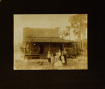Woman and Children Posing in Front of House
