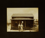 Woman and Man Standing in Front of House