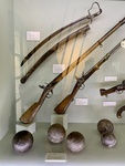 Sword and Scabbard (Top Left); Rifle from France, Spark Type (Middle); Carbine Rifle, Spark Type; Canon Balls, Iron  (Bottom). Enrique Udaondo Museum, Luján, Buenos Aires
