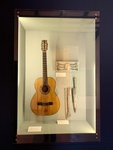 (Clockwise) Guitar, Silver Belt Buckle, and Knife with Scabbard: Gaucho Room. Enrique Udaondo Museum, Luján, Buenos Aires