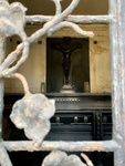 View of Crucufix and Coffin Through Window With Bronze Grille Featuring Floral Design. Recoleta Cemetery. 1