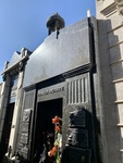 Facade of Duarte Family Mausoleum, With Plaques and Flowers and a View of Neighboring Mausoleums and Tombs. Recoleta Cemetery 2