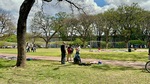 People enjoying warm weather in Parque Los Andes, Buenos Aires while engaging in various activities and socializing outdoors by Wendy Howard