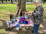 Students gather for discussion under a tree in Parque Los Andes, Buenos Aires, during a warm afternoon by Wendy Howard