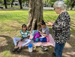 Group of students studying under a tree in Parque Los Andes, Buenos Aires on a sunny day by Wendy Howard